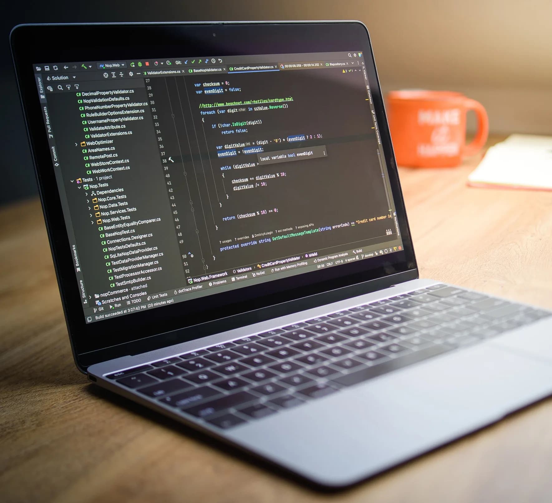 Laptop displaying code on a desk.